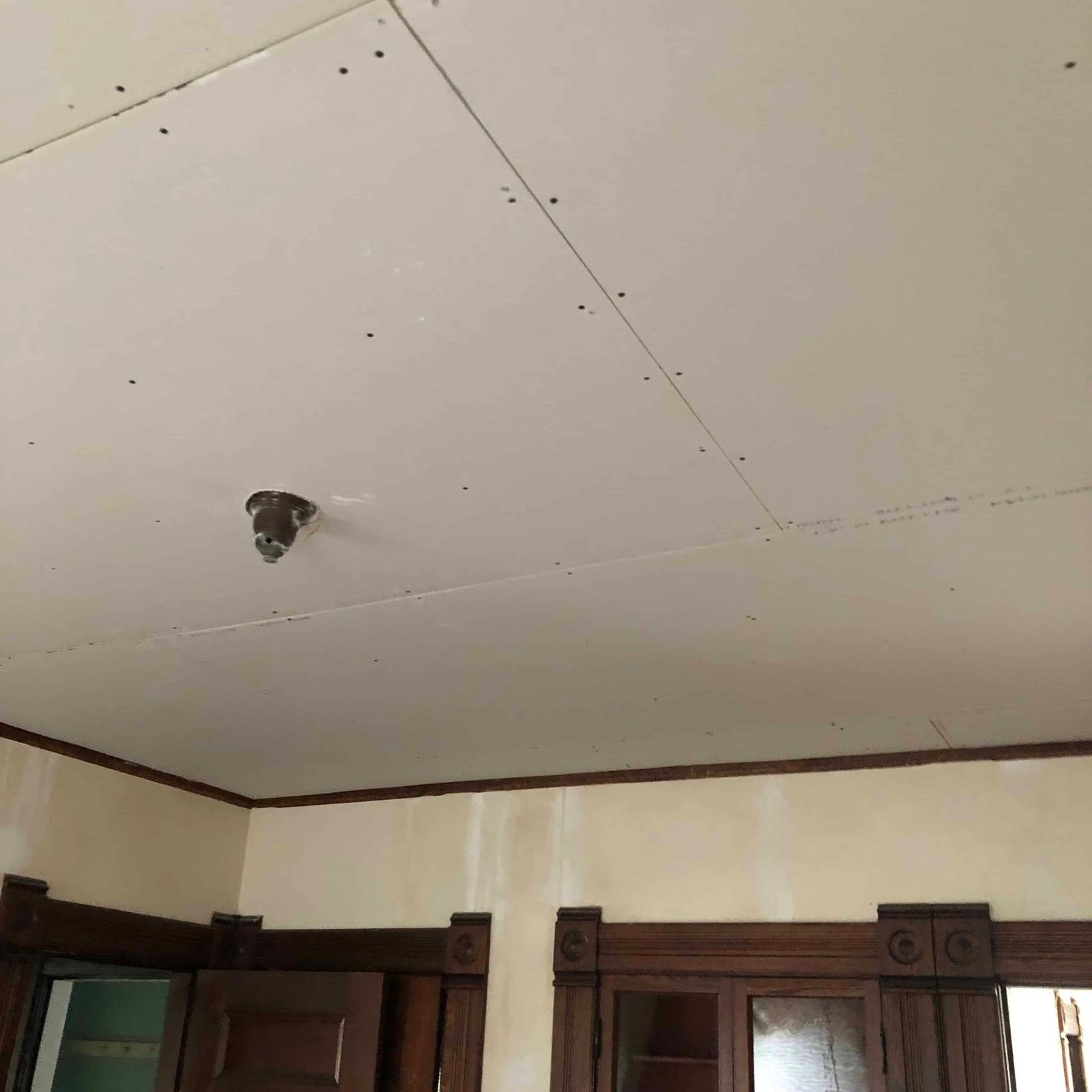 sheetrock ceiling installed over plaster